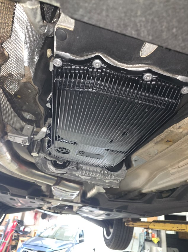 New black transmission pan bolted to the ZF 8-speed transmission under a 2021 BMW X3