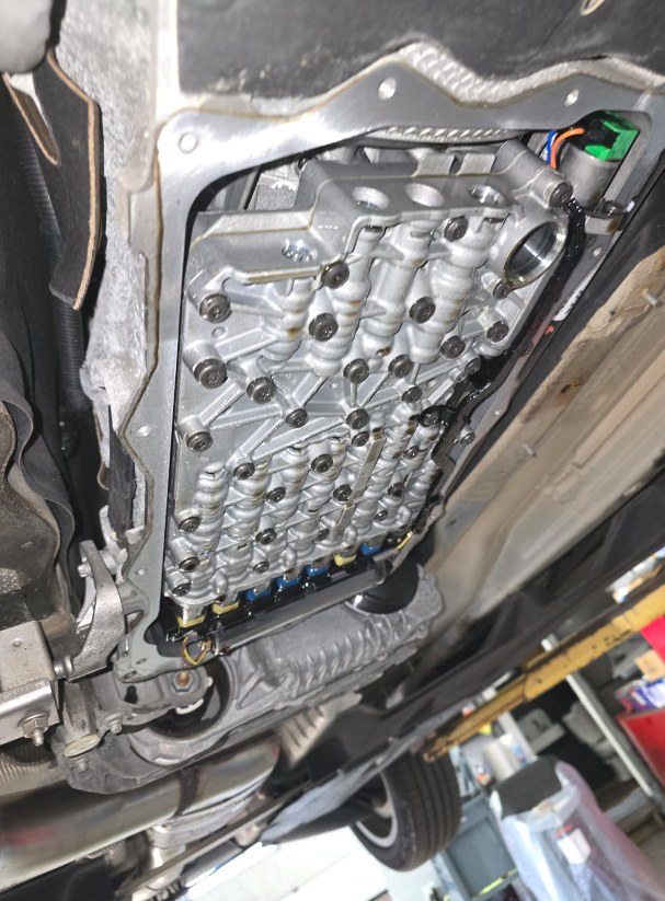 The valve body of a BMW X3 ZF 8-speed transmission exposed under the car with the pan removed